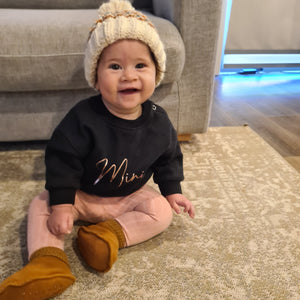 Frankie looking snuggley and warm wearing a beanie & her black Mini jumper from our Mothers day limited edition jumpers.
