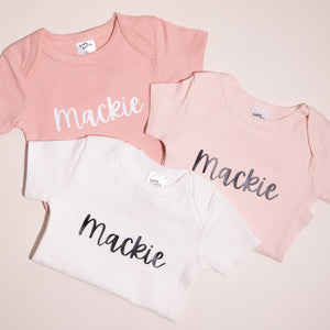 Our Get Started Pack includes 3 personalised onesies. Add a name, initial or any wording with your choice of onesie colour & font! This pack is the perfect gift for a new baby in your life, or if you just want some custom pieces for your kid!